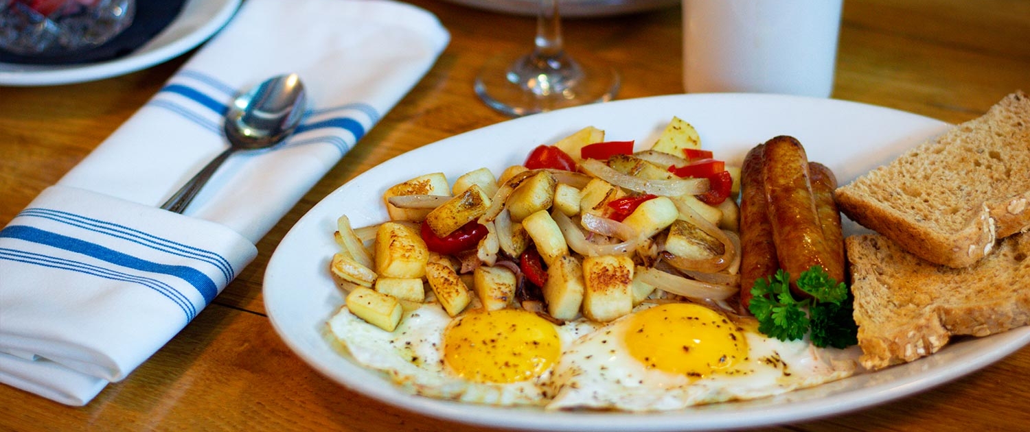 classic breakfast with 2 eggs, 3 link sausages, toast and breakfast potatoes