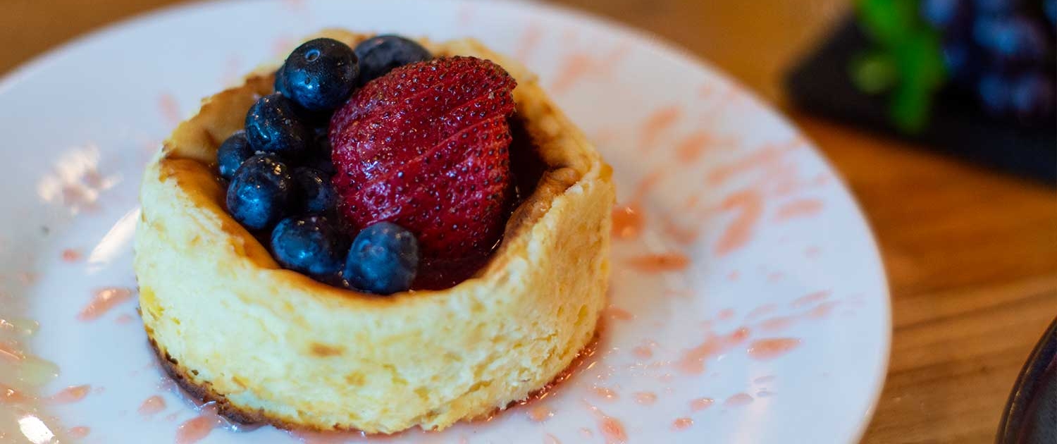 vanilla basque cheesecake with fresh strawberries and blueberries